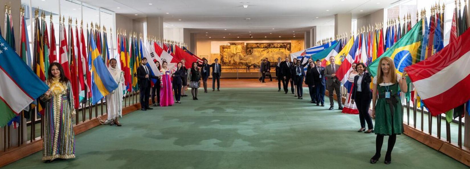 Guias da ONU posam para uma foto com suas respectivas bandeiras por ocasião do aniversário das Visitas Guiadas das Nações Unidas. 