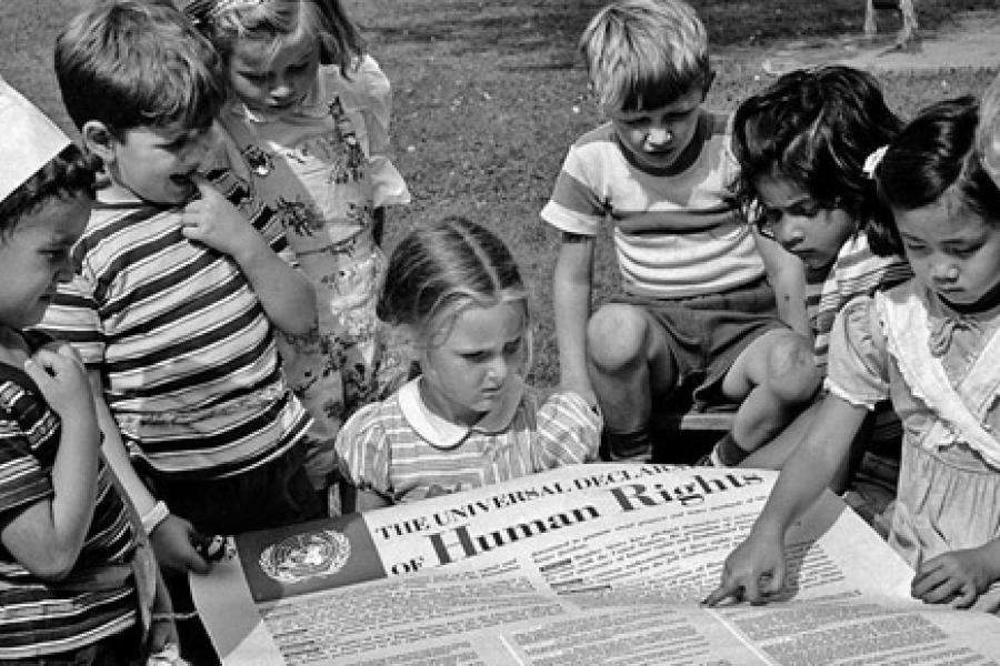 Crianças lendo a Declaração Universal dos Direitos Humanos (DUDH), pouco após sua adoção