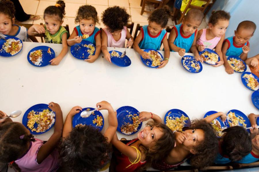 Crianças fazem uma refeição na escola, que participa de um programa de alimentação escolar na América Latina e no Caribe