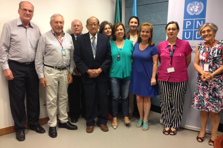 No centro, de terno escuro, Milton Thiago de Mello em reunião da associação de aposentados das Nações Unidas no Brasil 