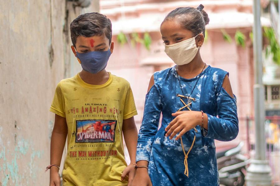 Um menino e uma menina na Índia se protegem contra COVID-19 usando máscaras faciais