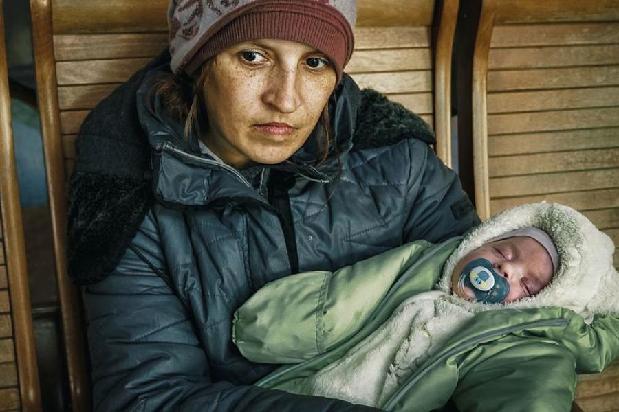 Uma mãe com seu filho de dois meses em uma estação de trem em Uzhhorod, na Ucrânia, depois de fugir de uma área de conflito